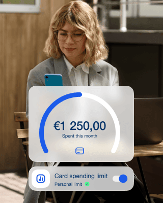 A woman sets the card spending limit via the app on her phone