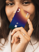 A girl holding a Visa card