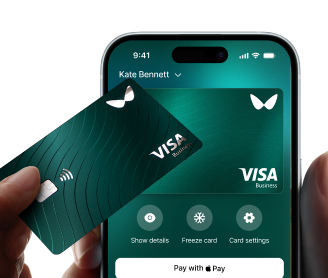 Wallester payment cards in hand: a phone with a virtual card image in one hand and a physical card in the other