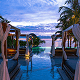 floating beds in the pool next to palm trees